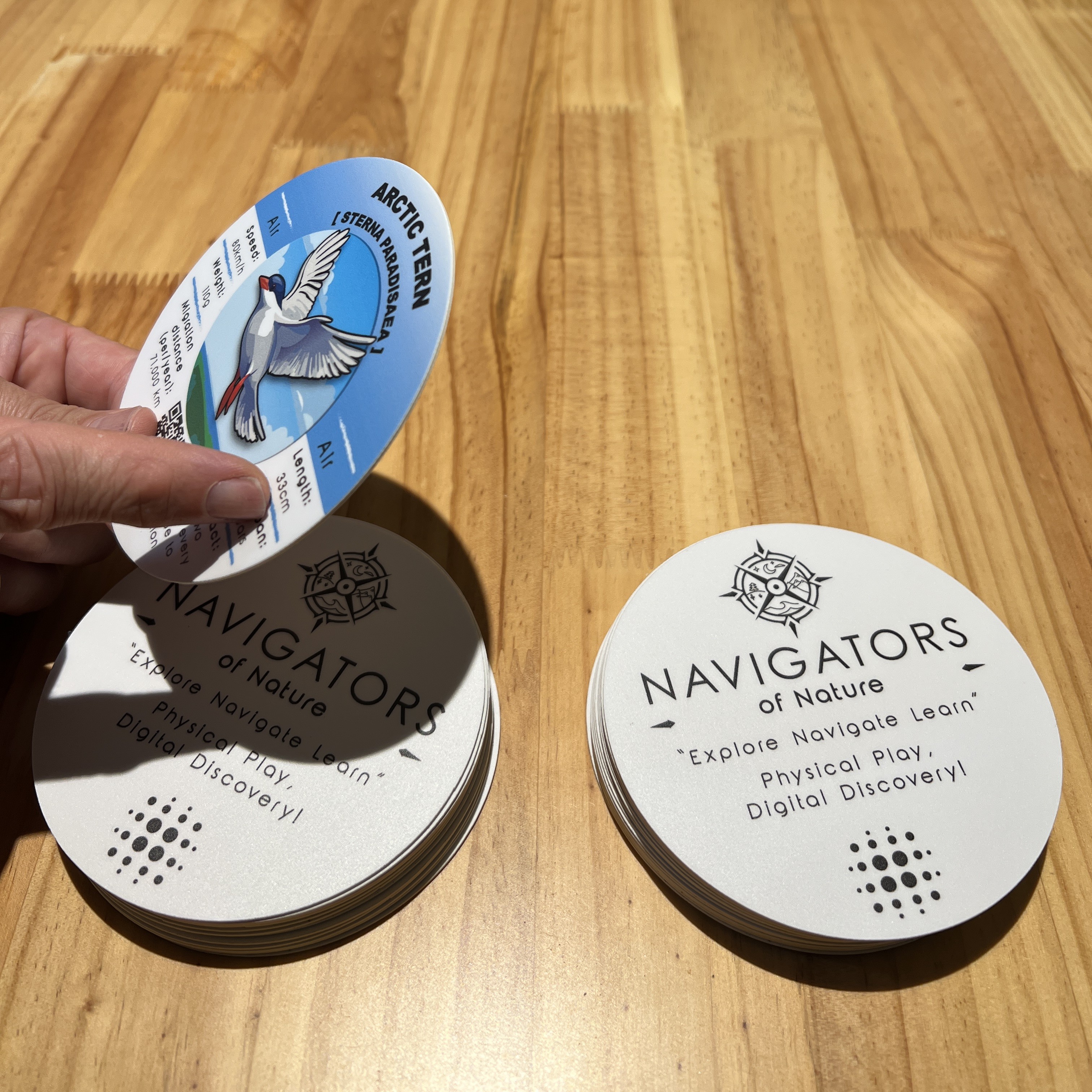 Players interacting with physical gameplay cards